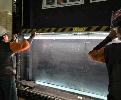 two men working on glass machine